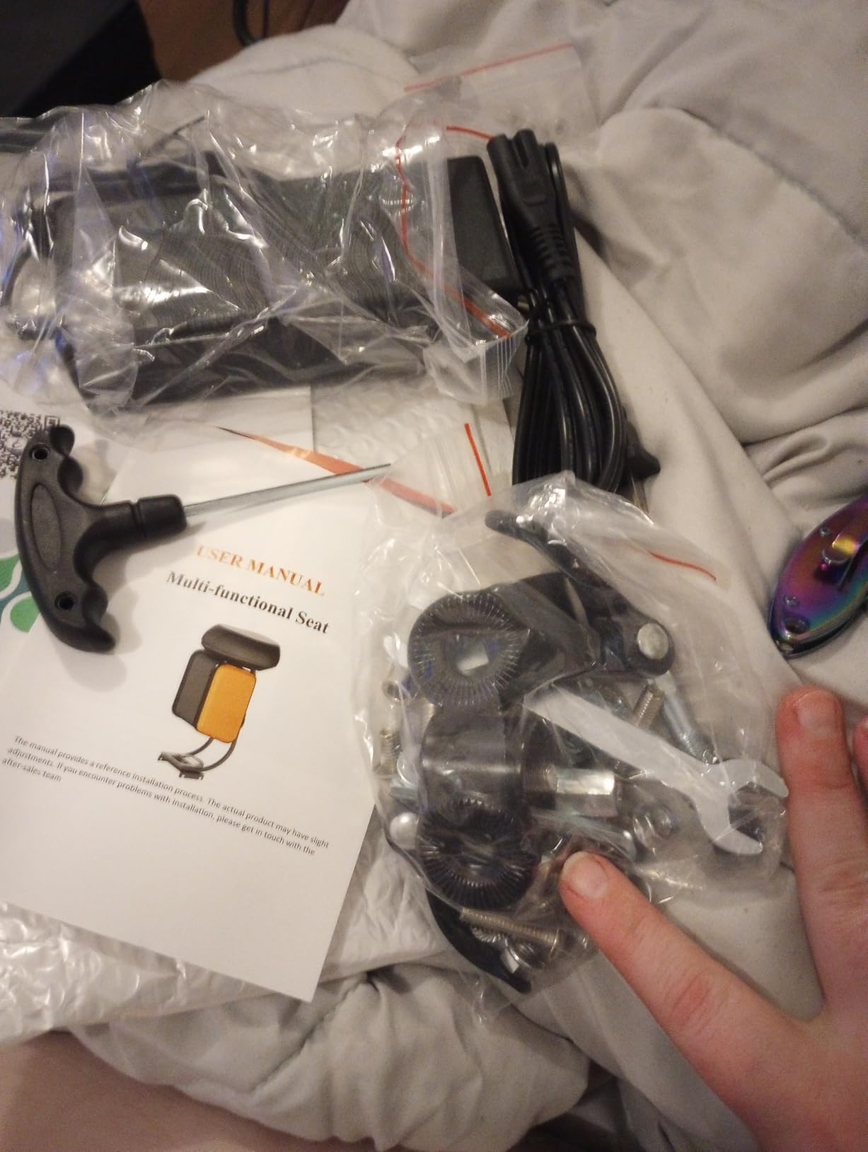 Unboxed WTRHXA seat hardware, T-handle wrench, charger and the multi-functional seat user manual